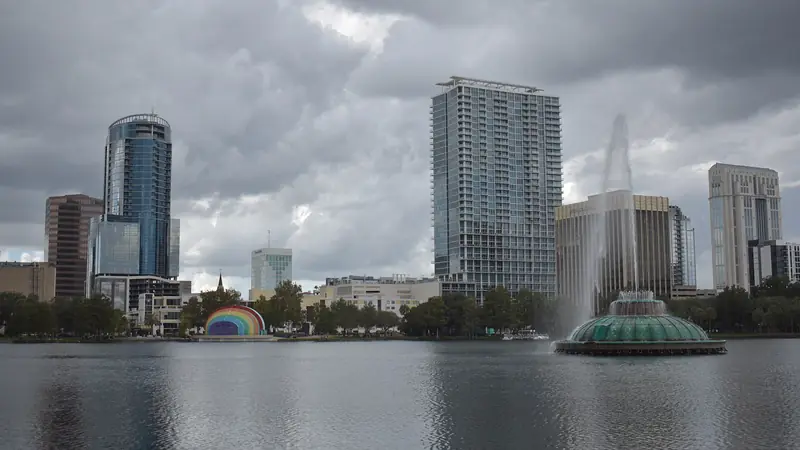 Lake Eola fountain in front of the downtown Orlando skyline under a cloudy sky