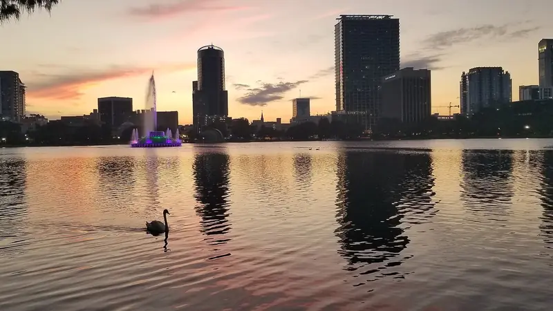 Sunset over Lake Eola with the downtown Orlando skyline reflected in the water